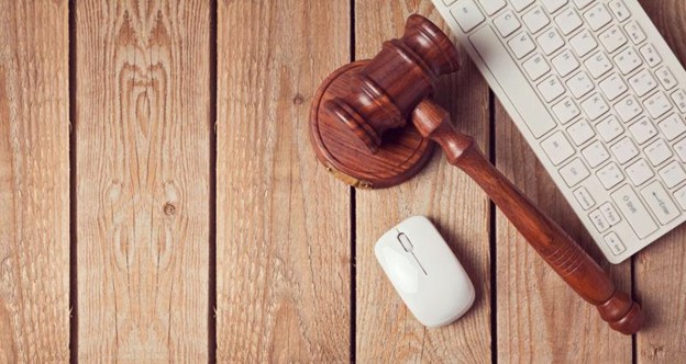 Gavel and block beside a mouse and keyboard, symbolic of criminal defense marketing
